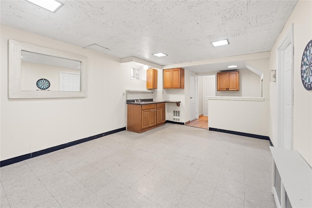62 Murray Ave, Yonkers, NY 10704 - kitchen with brown cabinetry, light flooring, and radiator heating unit