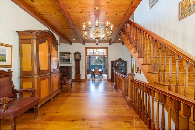 215 Hillcrest Dr N, Orient, NY 11957 - corridor featuring a chandelier, light wood-type flooring, a wooden ceiling with exposed beams, and stairs