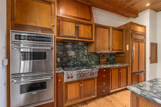 215 Hillcrest Dr N, Orient, NY 11957 - kitchen with stainless steel appliances, brown cabinetry, light wood finished floors, tasteful backsplash, and a wooden ceiling with exposed beams