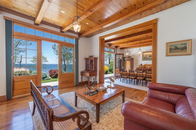215 Hillcrest Dr N, Orient, NY 11957 - living room featuring a wood ceiling with exposed beams, light wood-style flooring, and a water view
