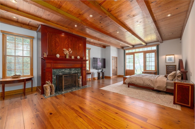 215 Hillcrest Dr N, Orient, NY 11957 - bedroom featuring a wooden ceiling with exposed beams, hardwood / wood-style floors, and a premium fireplace