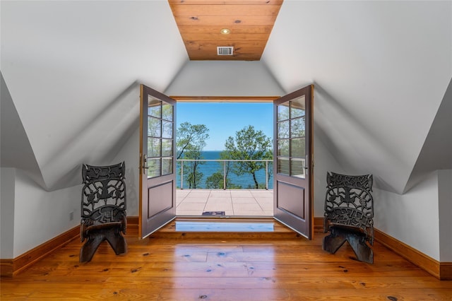 215 Hillcrest Dr N, Orient, NY 11957 - doorway to outside with lofted ceiling, plenty of natural light, hardwood / wood-style flooring, and a water view