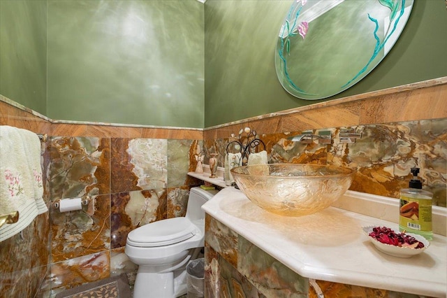 135 Millet St N, Dix Hills, NY 11746 - half bath with toilet, tile walls, vanity, and a wainscoted wall