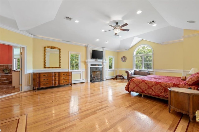 135 Millet St N, Dix Hills, NY 11746 - bedroom with a wainscoted wall, light wood-style floors, vaulted ceiling, a fireplace, and a baseboard heating unit