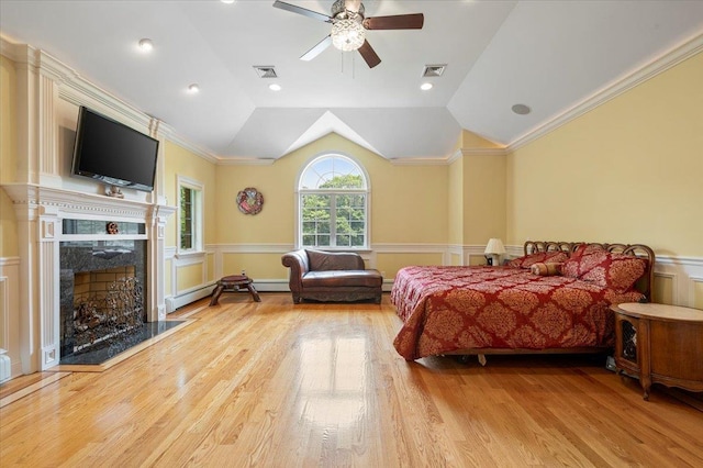 135 Millet St N, Dix Hills, NY 11746 - bedroom featuring wainscoting, ornamental molding, wood finished floors, lofted ceiling, and a fireplace
