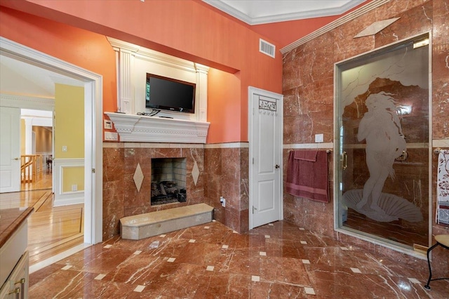 135 Millet St N, Dix Hills, NY 11746 - unfurnished living room with tile walls, a premium fireplace, crown molding, marble tiled floors, and a wainscoted wall