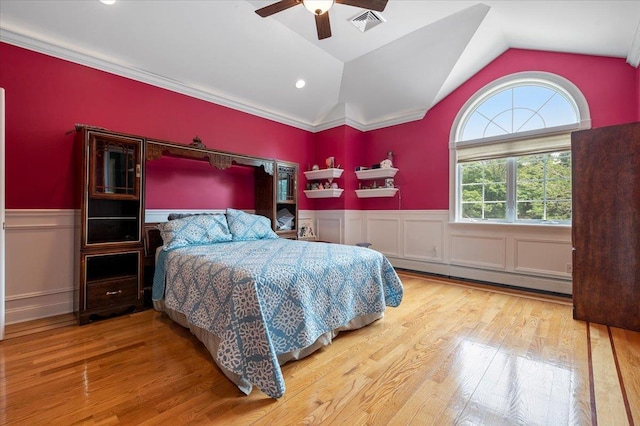 135 Millet St N, Dix Hills, NY 11746 - bedroom with wainscoting, a baseboard radiator, wood finished floors, lofted ceiling, and ceiling fan