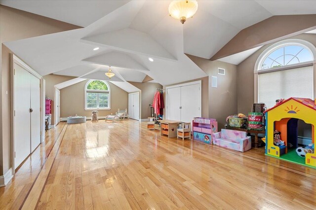 135 Millet St N, Dix Hills, NY 11746 - recreation room with vaulted ceiling, hardwood / wood-style flooring, a baseboard radiator, and baseboards