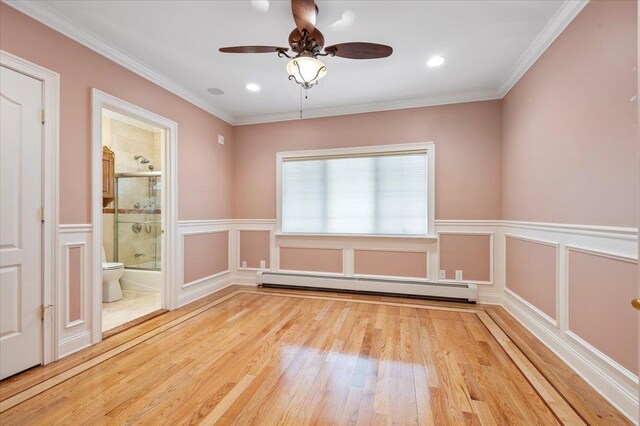 135 Millet St N, Dix Hills, NY 11746 - unfurnished room featuring a baseboard radiator, wood finished floors, a decorative wall, a wainscoted wall, and a ceiling fan