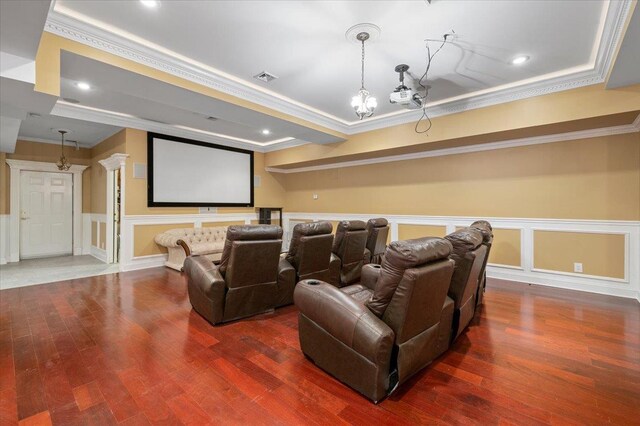 135 Millet St N, Dix Hills, NY 11746 - home theater room with crown molding, wood finished floors, a raised ceiling, a decorative wall, and a wainscoted wall