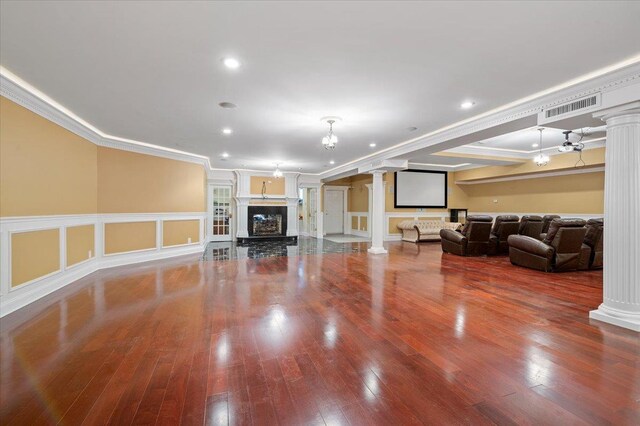 135 Millet St N, Dix Hills, NY 11746 - living room with decorative columns, ornamental molding, wood finished floors, a fireplace with raised hearth, and recessed lighting