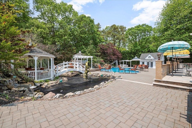 135 Millet St N, Dix Hills, NY 11746 - outdoor pool with a gazebo, a patio, view of scattered trees, and an outdoor structure