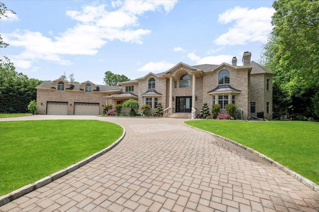 135 Millet St N, Dix Hills, NY 11746 - view of front of home featuring curved driveway, a chimney, a front lawn, and french doors