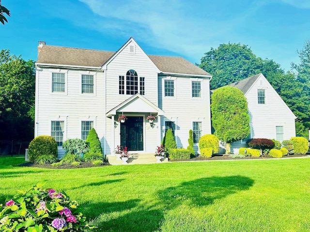 1 Ada Ln, East Setauket, NY 11733 - view of front of house featuring a front lawn and a chimney