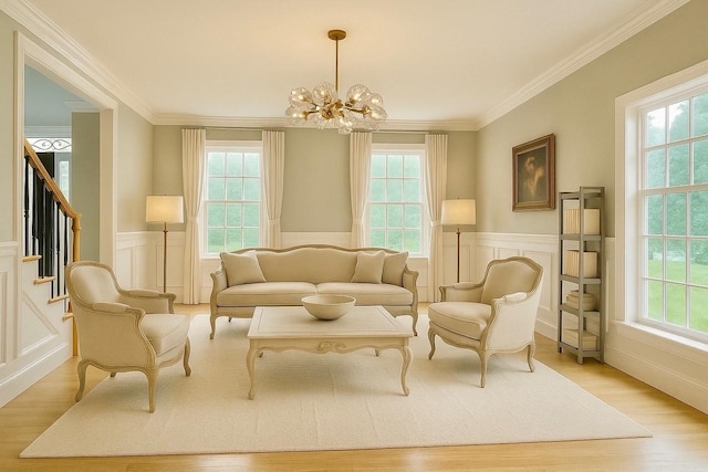 1 Ada Ln, East Setauket, NY 11733 - sitting room featuring healthy amount of natural light, a wainscoted wall, light wood-type flooring, a chandelier, and ornamental molding