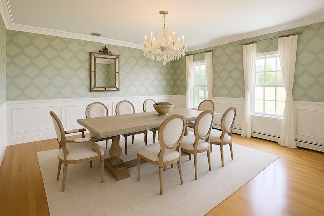 1 Ada Ln, East Setauket, NY 11733 - dining space featuring a chandelier, crown molding, light wood finished floors, wainscoting, and wallpapered walls