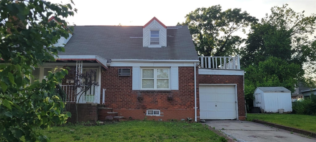 6 Newburgh St, Elmont, NY 11003 - cape cod house featuring brick siding, a shed, a front lawn, and driveway