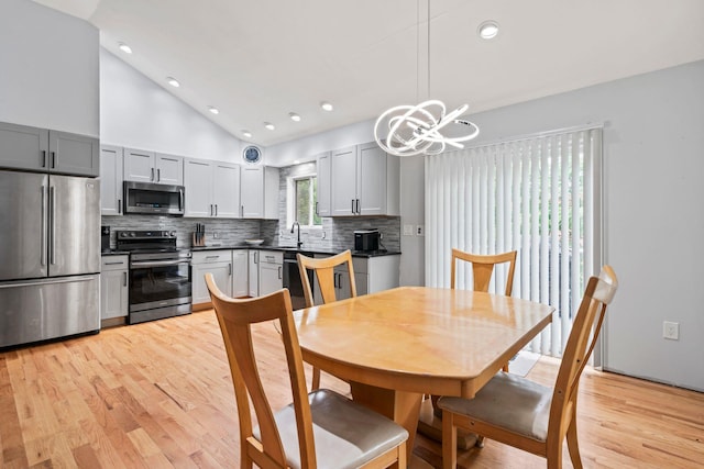 36 Maple Rd, Kings Park, NY 11754 - dining area with lofted ceiling, a chandelier, light wood finished floors, and recessed lighting