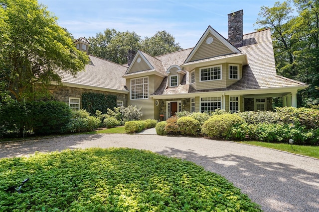 28 Stone Paddock Pl, Bedford, NY 10506 - shingle-style home featuring stone siding and a chimney