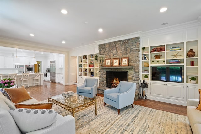 28 Stone Paddock Pl, Bedford, NY 10506 - living room with crown molding, light wood finished floors, a fireplace, recessed lighting, and built in features