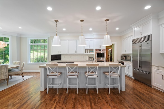 28 Stone Paddock Pl, Bedford, NY 10506 - kitchen with appliances with stainless steel finishes, tasteful backsplash, an island with sink, dark wood-style flooring, and white cabinets