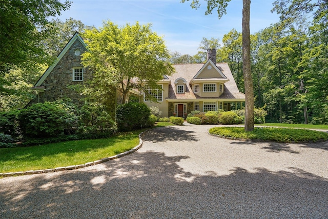 28 Stone Paddock Pl, Bedford, NY 10506 - shingle-style home featuring stone siding, driveway, a chimney, and a front yard