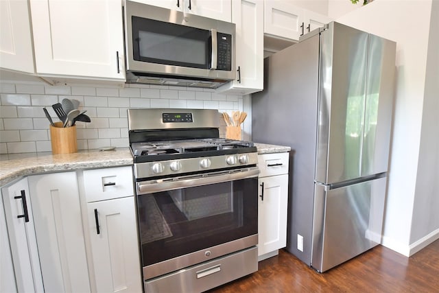 6 Zebra Rd, Rocky Point, NY 11778 - kitchen with stainless steel appliances, white cabinetry, tasteful backsplash, and dark wood-style floors