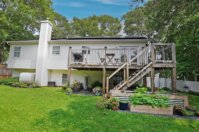6 Zebra Rd, Rocky Point, NY 11778 - rear view of property featuring a vegetable garden, a deck, and a chimney