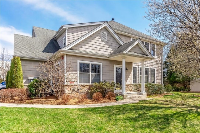 1200 Half Moon Bay Dr, Croton-On-Hudson, NY 10520 - view of front of property with stone siding, a front yard, and roof with shingles