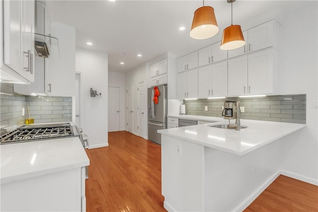 1200 Half Moon Bay Dr, Croton-On-Hudson, NY 10520 - kitchen with appliances with stainless steel finishes, light wood-style flooring, white cabinetry, and recessed lighting