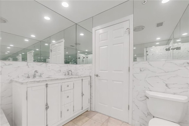 1200 Half Moon Bay Dr, Croton-On-Hudson, NY 10520 - bathroom featuring tile walls, a marble finish shower, double vanity, and recessed lighting