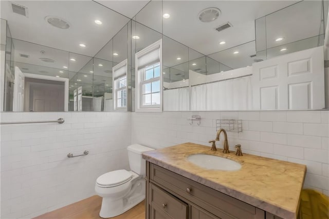 1200 Half Moon Bay Dr, Croton-On-Hudson, NY 10520 - bathroom with tile walls, walk in shower, vanity, and wood finished floors