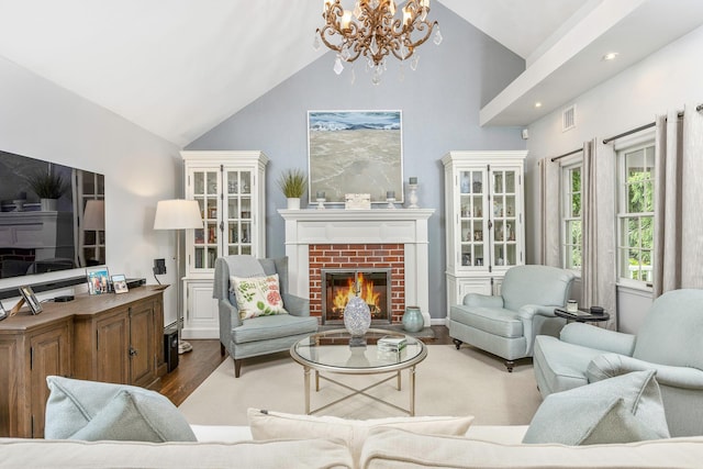 15 Hermitage St, Wading River, NY 11792 - living area with high vaulted ceiling, a chandelier, wood finished floors, a fireplace, and recessed lighting