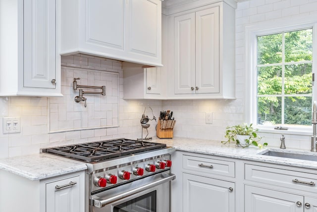 15 Hermitage St, Wading River, NY 11792 - kitchen with stainless steel stove, backsplash, and white cabinets