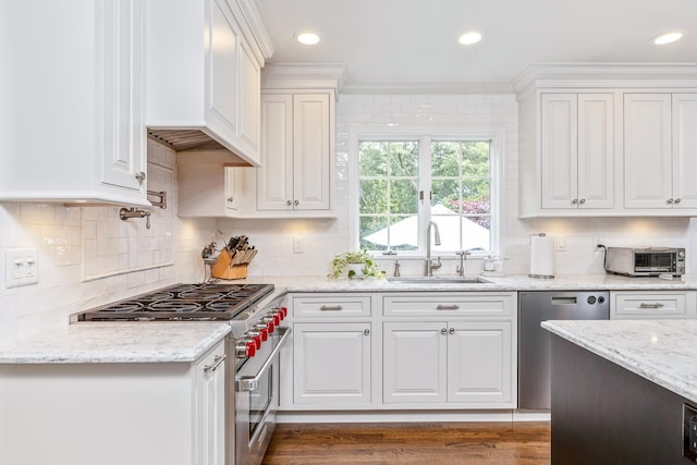 15 Hermitage St, Wading River, NY 11792 - kitchen featuring appliances with stainless steel finishes, white cabinetry, ornamental molding, decorative backsplash, and light stone countertops