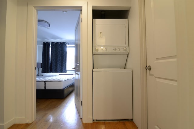 132-35 41st Rd Unit 5D, Flushing, NY 11355 - washroom featuring stacked washing machine and dryer and light wood-type flooring