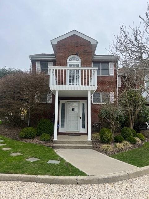 32D Library Ave Unit 4, Westhampton Beach, NY 11978 - view of front of home featuring a balcony and brick siding