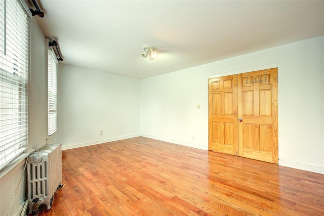 56-20 68th St, Maspeth, NY 11378 - spare room with radiator heating unit and light wood-type flooring