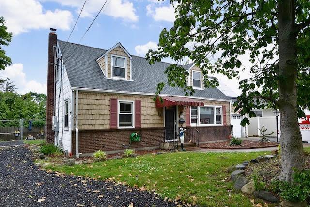 70 Islip Ave, Islip, NY 11751 - cape cod-style house with a chimney, brick siding, and a shingled roof