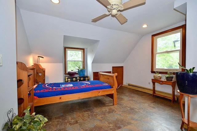 70 Islip Ave, Islip, NY 11751 - bedroom with vaulted ceiling, multiple windows, recessed lighting, a baseboard heating unit, and a ceiling fan