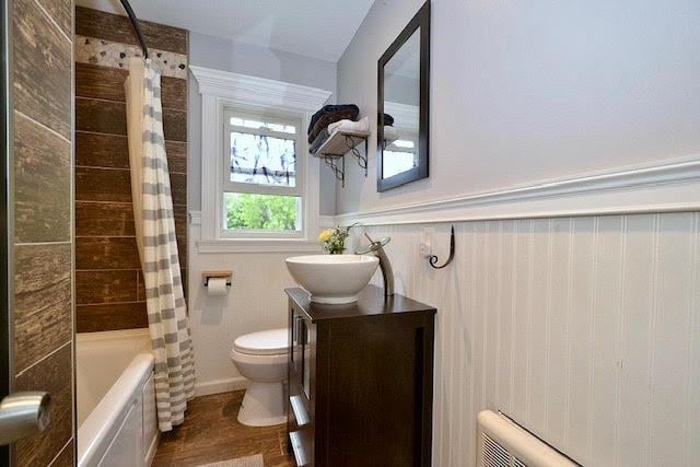 70 Islip Ave, Islip, NY 11751 - bathroom with vanity, shower / tub combo, wainscoting, and wood finished floors