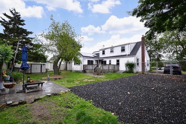 70 Islip Ave, Islip, NY 11751 - rear view of property featuring a patio, a chimney, a fenced backyard, and a deck