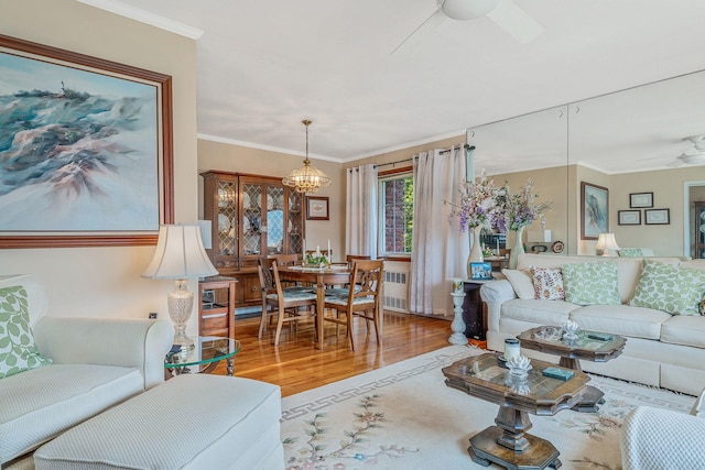 3324 Murdock Ave, Oceanside, NY 11572 - living area featuring a ceiling fan, wood finished floors, radiator, and crown molding