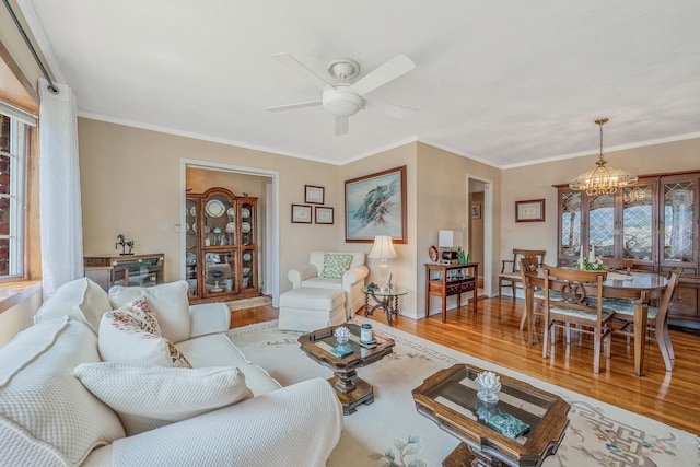 3324 Murdock Ave, Oceanside, NY 11572 - living room with wood finished floors, a chandelier, a ceiling fan, and ornamental molding