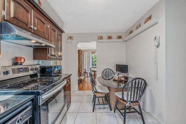 3324 Murdock Ave, Oceanside, NY 11572 - kitchen with stainless steel electric range, range hood, decorative backsplash, and dark countertops