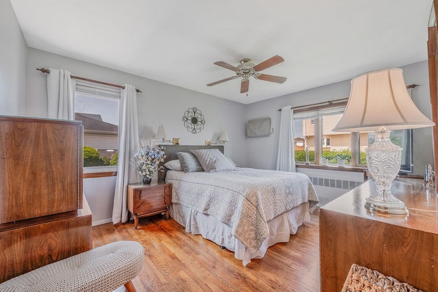 3324 Murdock Ave, Oceanside, NY 11572 - bedroom featuring radiator, light wood-style flooring, and ceiling fan