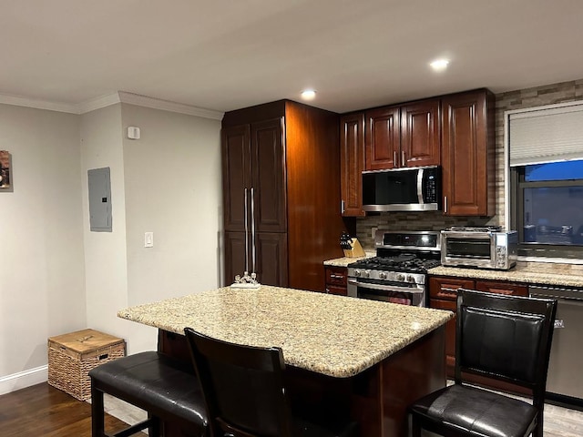 159-02 Cross Island Pkwy Unit 6-22, Whitestone, NY 11357 - kitchen with stainless steel appliances, electric panel, dark wood-type flooring, a kitchen bar, and light stone countertops