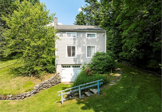 252 Ernest Rd, Millbrook, NY 12545 - rear view of property with a chimney, a lawn, and an attached garage