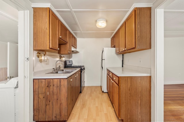 252 Ernest Rd, Millbrook, NY 12545 - kitchen with gas range, freestanding refrigerator, light wood finished floors, and brown cabinetry