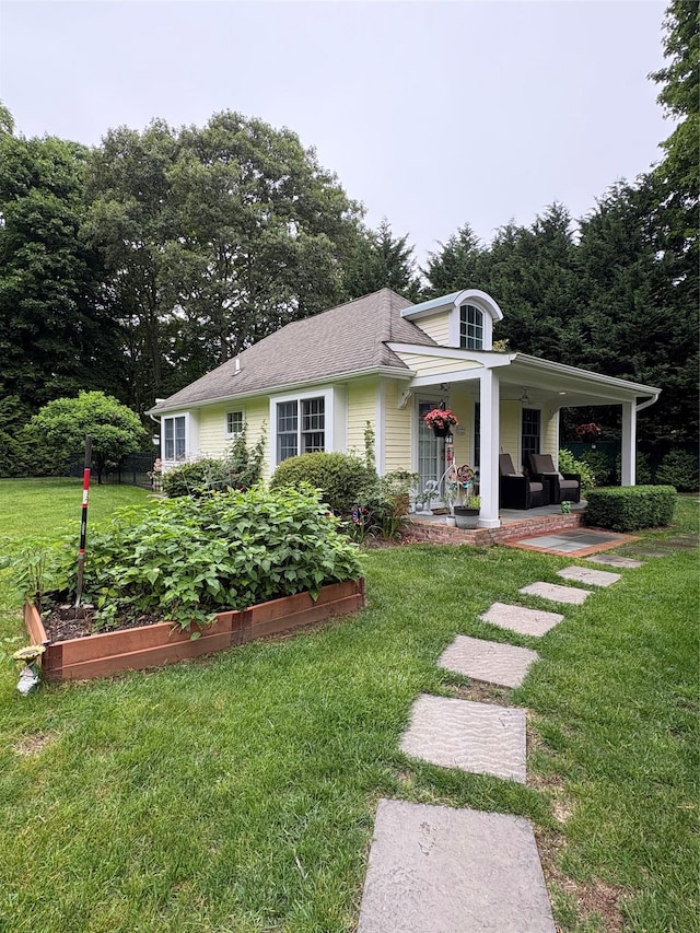 120 Cambon Ave, Saint James, NY 11780 - view of front of house featuring a garden, a porch, and a front lawn